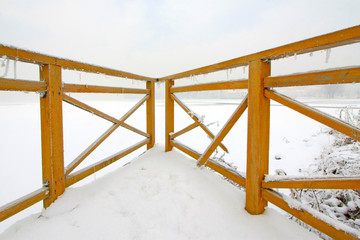 Wooden baluster in the snow