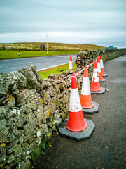 Traffic cones protecting traditional dry stone wall