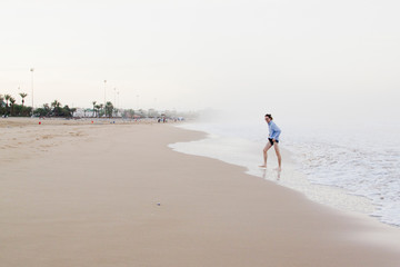 A man on the ocean at sunrise