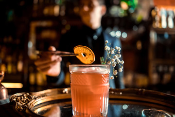 Bartender decorate apricot and sage sour. Selective focus