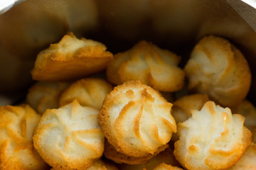 Christmas coconut puffs macaroon cookies in tin box. Festive cozy atmosphere. Holiday pastry baking concept. Italian French cuisine