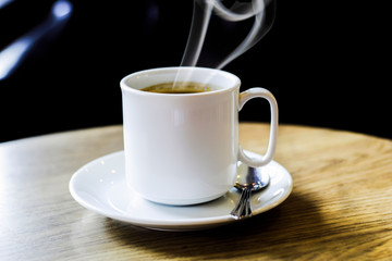 Hot coffee on the wooden table
