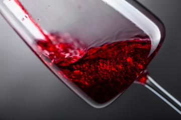 Red wine being poured into wineglass.