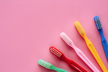 Toothbrush used for cleaning the teeth on pink background for dental care concept