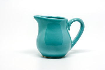 Green small ceramic pitcher on white background for utensil and dishware concept