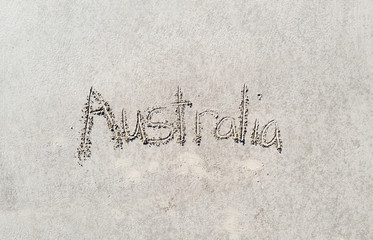 Australia written in the sand at the beach.