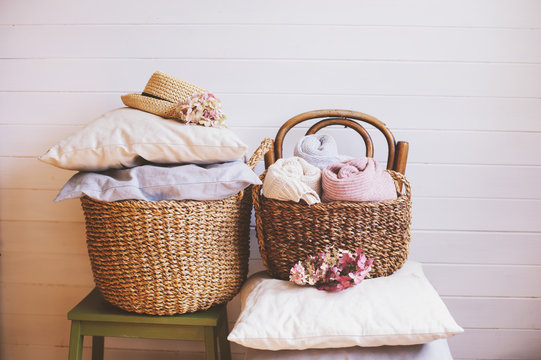 cozy still life interior details. Organizing clothes in wicker backets, seasonal wardrobe cleaning, ideas for winter season.