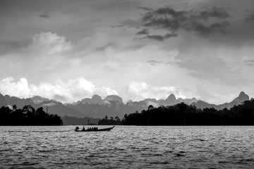 Dramatic black and white boat in the lake, Suratthani, Thailand.
