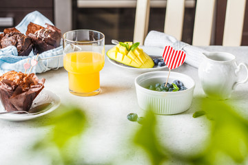 Breakfast on Valentine's Day served with muffins, juice, berries and fruit.