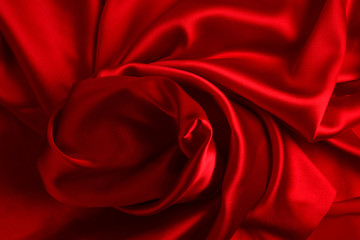 Red silk or satin luxury fabric texture can use as abstract background. Top view