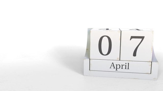 Wood cube calendar shows April 7 date, 3D animation