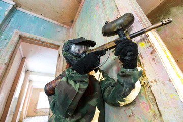 Fototapeta premium Extreme paintball workout in old abandoned building