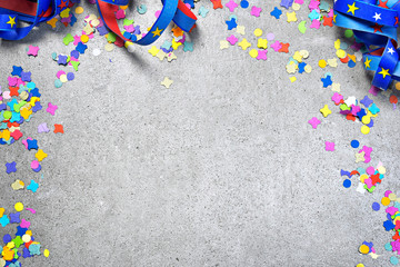 Obraz premium Birthday or holiday background with multicolored confetti on a white background. Celebration background with curly ribbon and copy space.