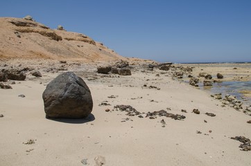 Fototapeta na wymiar Big brown stone on the sea shore.