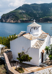 The white Monastery of Evangelistria with stone tile on Skopelos town, Greece