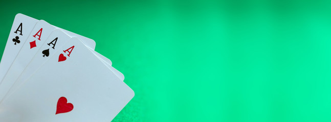 Playing cards, poker, casino. Four aces on green felt background