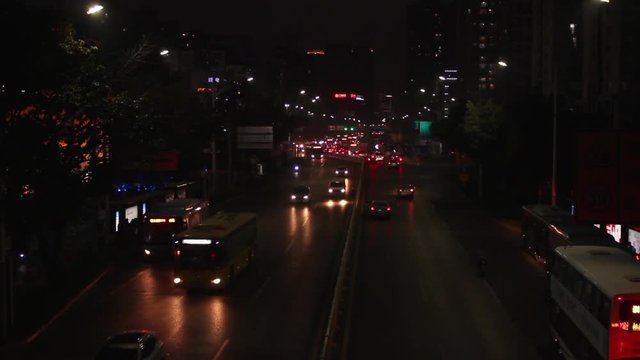 Shekou, Nanshan district Shenzhen, Guangdong province, China; cars and vehicles moving slowly at streets at night;