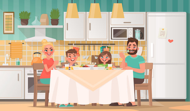 Happy family eating in the kitchen. Father, mother, son and daughter have breakfast at the table at home