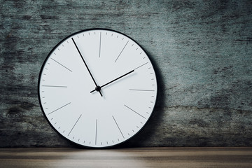 Classic round wall clock on a wooden background with copy space