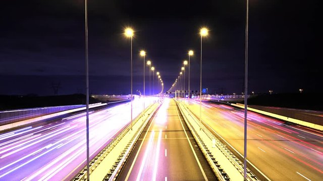 Time-lapse of evening traffic on a new wide A1 highway (motorway) with a reversible lane in the middle, located in The Netherlands