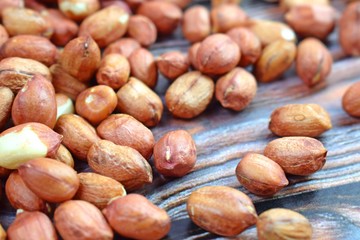 Obraz premium Peanuts on wooden background.Healthy.