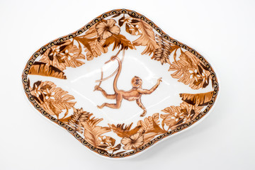 Fototapeta premium Saucer with image of a monkey in the jungle isolated on white background