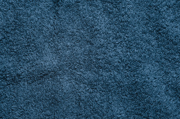 The texture of the fabric with a long nap. Blue textile blank background