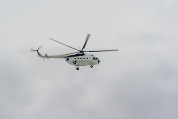 helicopter fly among a dense clouds