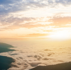 mountain valley in a dense clouds at the sunset