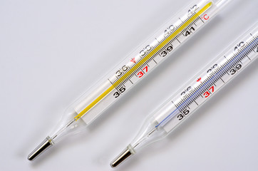 Glass medical thermometer thermometer for measuring body temperature shot on a white background