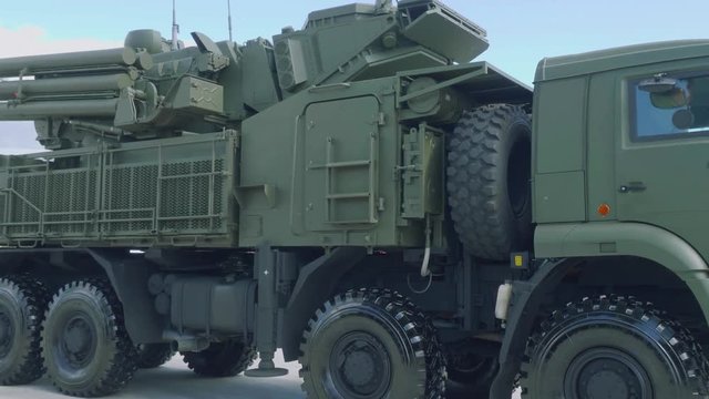 Side view of air defense missile gun system Pantsir-1 in green protective camouflage. Protection from threat in sky