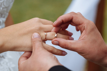 wedding couple wearing gold finger rings