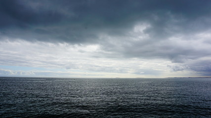 sea with blue sky and clouds
