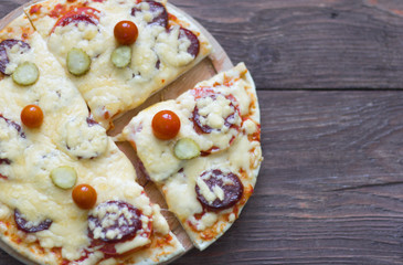 homemade traditional pepperoni pizza with salami and cheese, cherry tomatoes on top