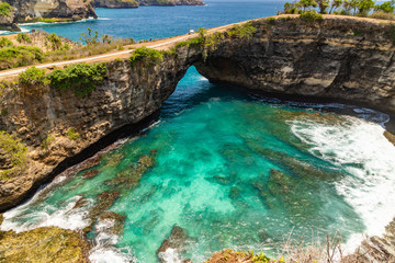 Beautiful landscape of a Broken Beach, located in Nusa Penida Island, the southeast island of Bali, Indonesia. The amazing tourist attraction of the rock, cliff, mountain, and ocean waves.