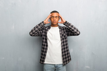 Young african american man with checkered shirt unhappy and frustrated with something