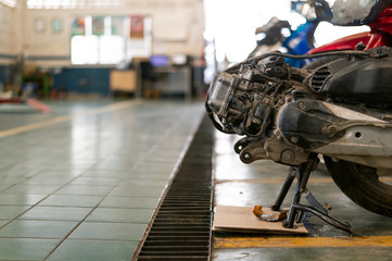 Fototapeta premium closeup motorcycle engine in repair station with soft-focus and over light in the background