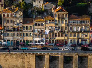 Fototapeta na wymiar typicall and colorfull house of porto in portugal with dom luis bridge as frame
