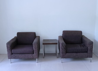 two old empty armchairs and coffee table in living room