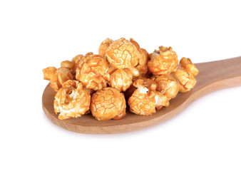 sweet butter caramel popcorn on wooden spoon and on white background
