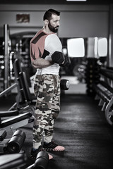 Fototapeta na wymiar Man doing workout with dumbbells