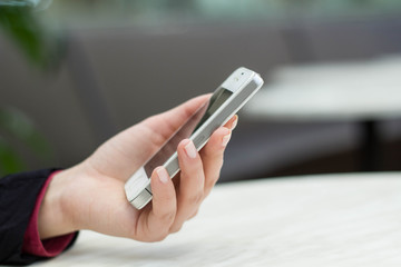female hand holding a mobile phone