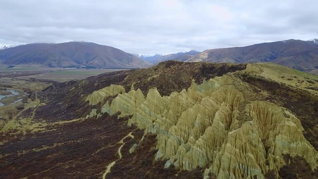 4K. Aerial view of clay cliffs near Omarama, natural rock formations in South Canterbury, South Island, New Zealand.