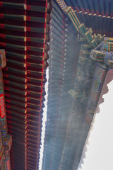 Fototapeta na wymiar Beijing. China. A fragment of the cornice of the Yonghegong Lama Temple roof.