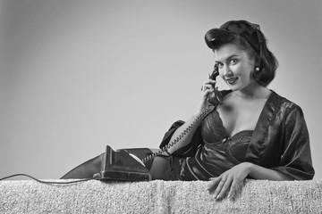 Beautiful woman speaking via vintage phone.