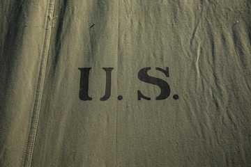 Green military tent fabric with U.S. initials