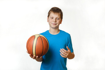 portrait of a teenage boy with a basketball ball on a white background, disappointed,  isolate