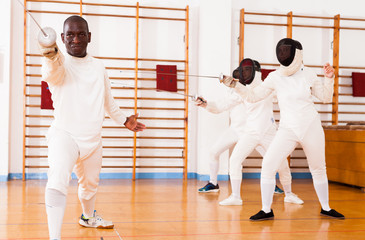 Sporty african american man fencer practicing effective fencing techniques