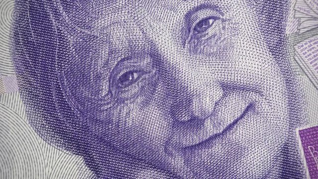 Astrid Lindgren portrait on Sweden 20 krona (2015) banknote rotating, Swedish money close up. 4K UHD video footage.