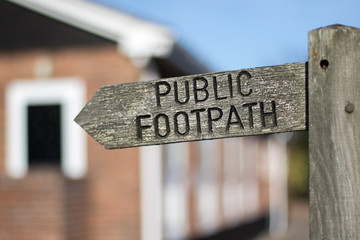 Public footpath sign. Right of way access through private property. Selective focus.